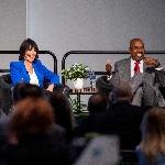 Grand Valley President Philomena V. Mantella and Ferris State President Bill Pink share a laugh on stage during a panel discussion.